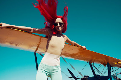 woman's hair flying, woman on airplane wing, fashion photographer new york city