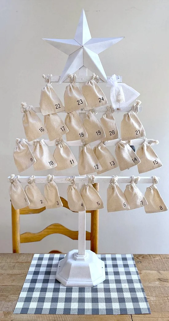 Standing white Christmas tree with muslin bags