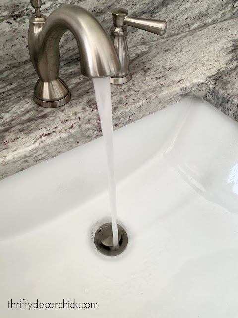 unclogged bathroom drain in white sink