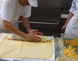 Making apple strudel at a bakery by Rudolf Simon