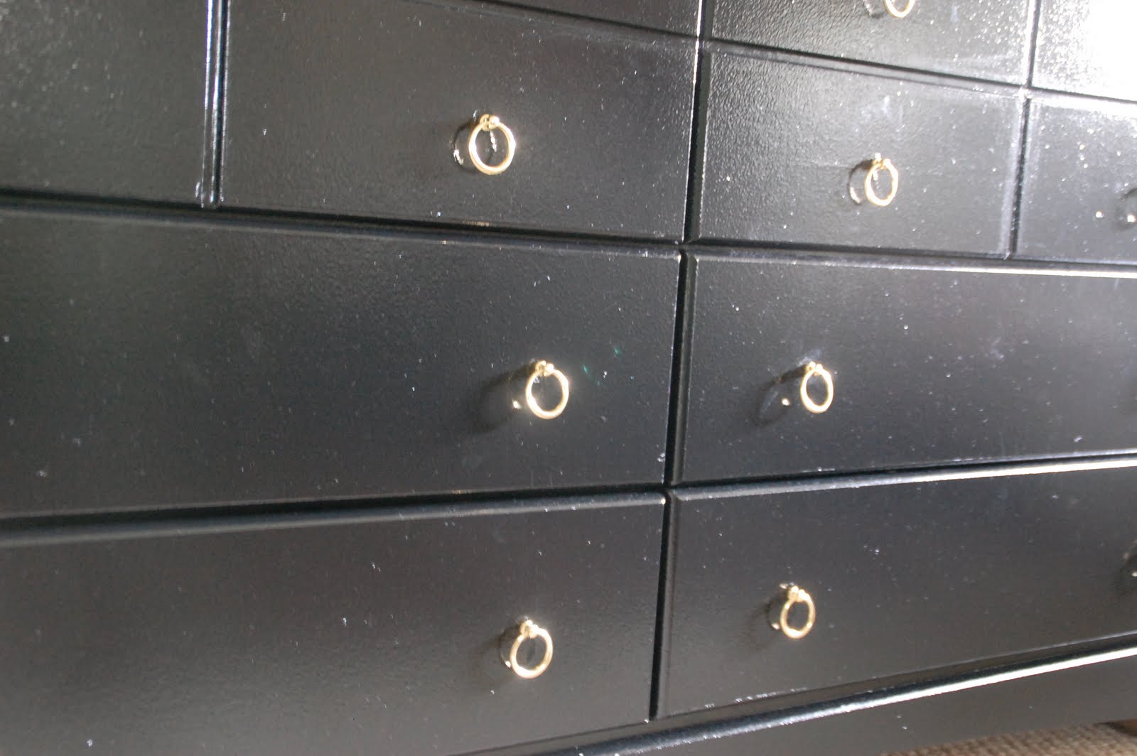 Lisa Moves black dressers with gold ring pulls