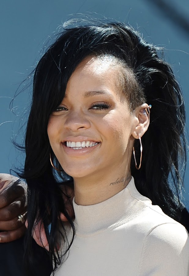 Rihanna smiles for cameras
