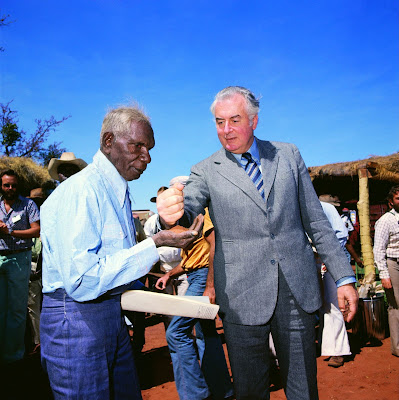 Mervyn Bishop's historic 1975 image captures then Prime Minister Gough Whitlam pouring a handful of earth back into the hand of Gurindji elder and traditional landowner Vincent Lingiari.