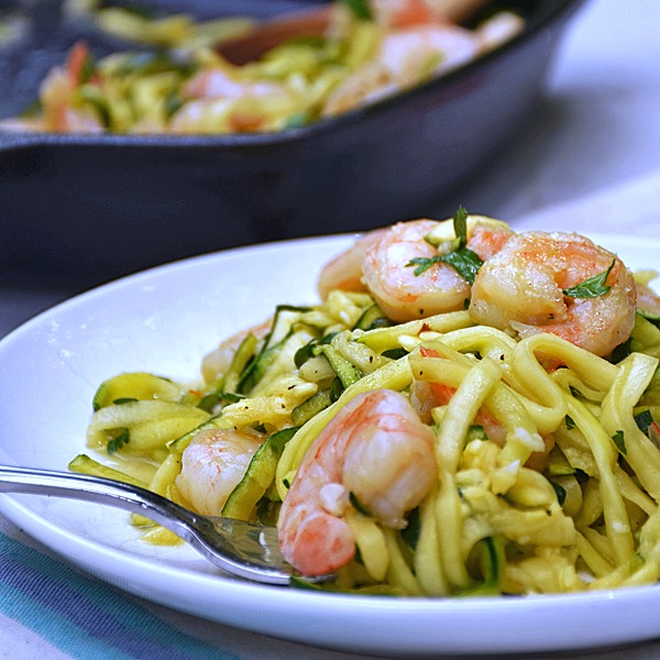 Shrimp Scampi Zoodles | by Life Tastes Good is a lower carb version of a traditional Shrimp Scampi recipe typically served over pasta. This recipe still has all the fresh tasting garlic and buttery goodness of the traditional recipe, but is served over zucchini noodles, or the more fun way of saying it 'zoodles', to get rid of all those carbs from the pasta. Just for the record... I didn't miss the pasta at all!