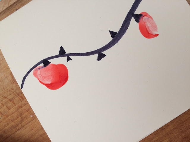 A folder card with a black curved line and finger paintings