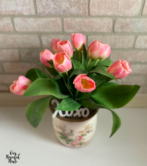 overhead pink tulips white brick background