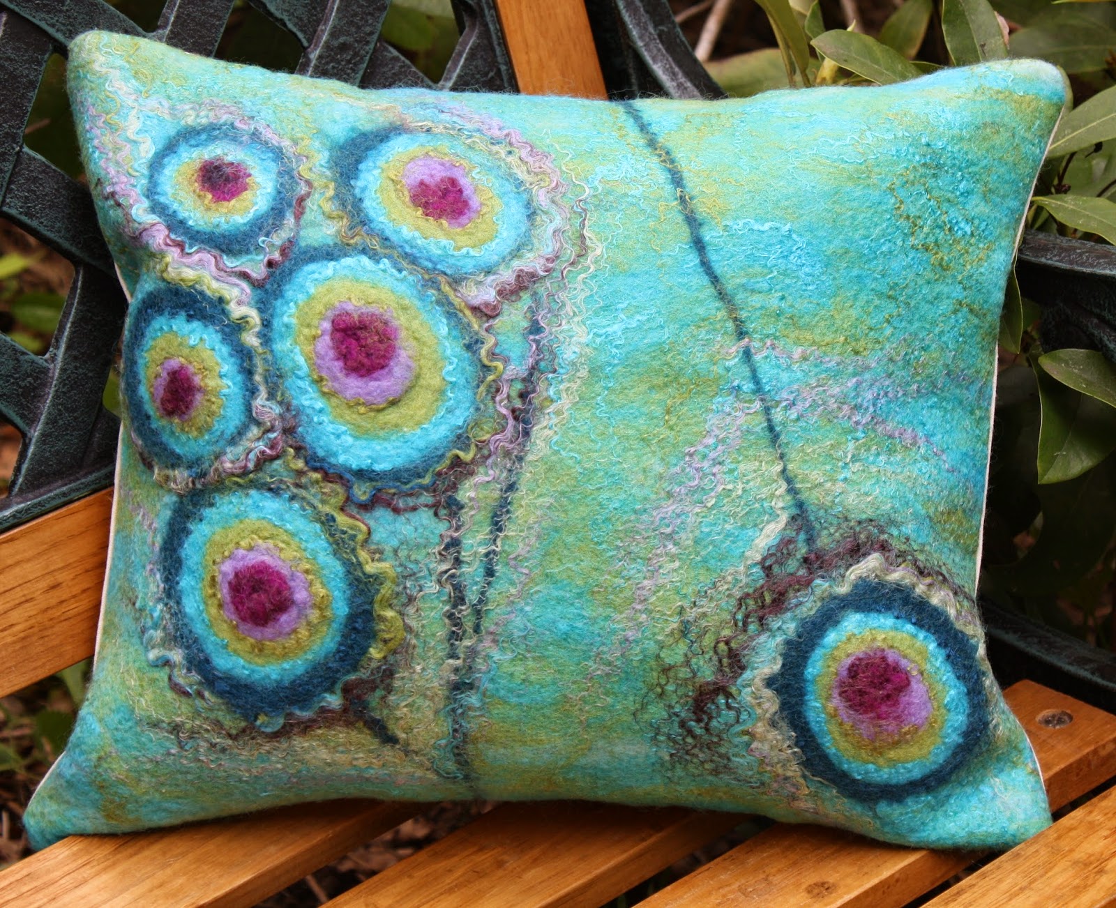 filc&felt handmade by mewa eyes of peacock's tail wool painted on a wet felted pillow