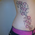Star and bale tattoo on side body