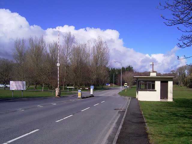 hospital gate lodge and entrance way, with bus stop and access barrier in park setting of Merlin Woods on the Dublin Rd, Galway.  Sunny winter day in December.