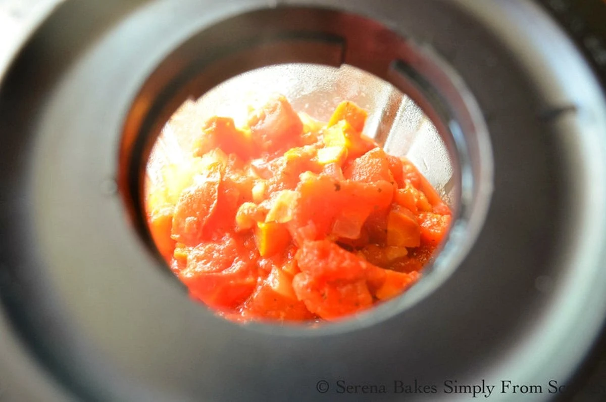 Crock Pot Tomato Soup in a blender looking down through hole.