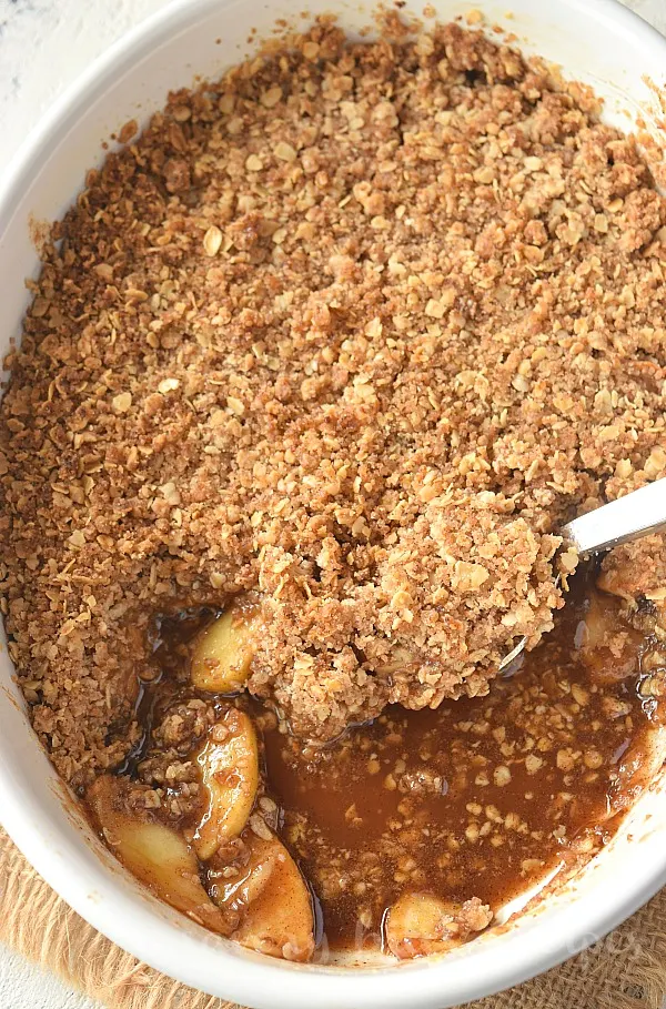 a white dish with delicious old fashioned apple crisp with oats topping