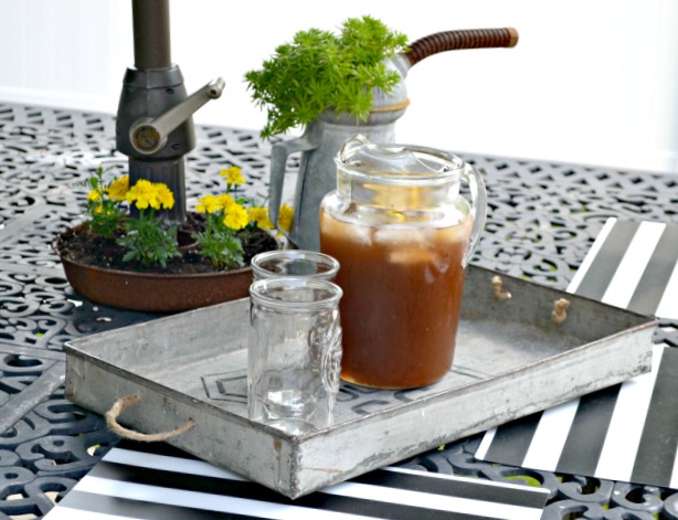 Outdoor table with Metal Tray and Iced tea pitcher and glass.