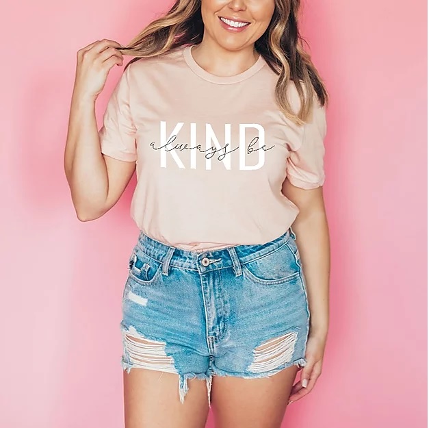 Woman wearing a pink tshirt that says always be kind