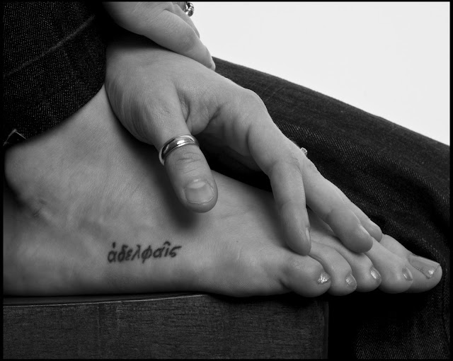 photo by Eugene Pierce of feet and hands with tattoo in black and white