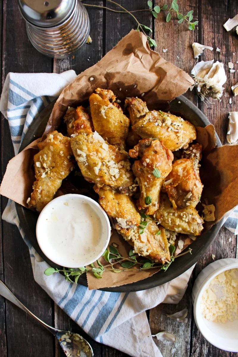 Air Fryer Garlic Parmesan Chicken Wings are extra crispy wings tossed in seasoned garlic butter sauce and parmesan cheese. Try them dipped in caesar dressing and you'll be hooked! #chickenwings #appetizer