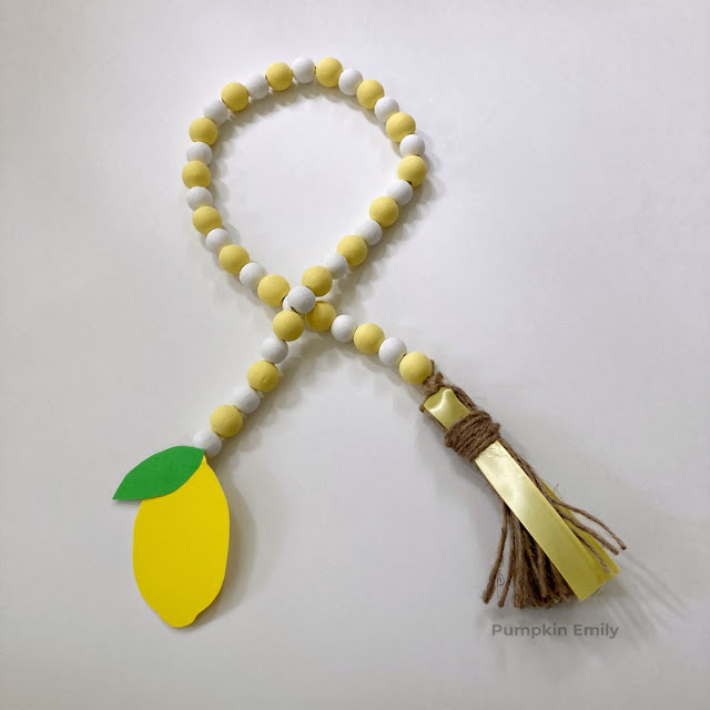 A lemon wood bead garland with a tassel.