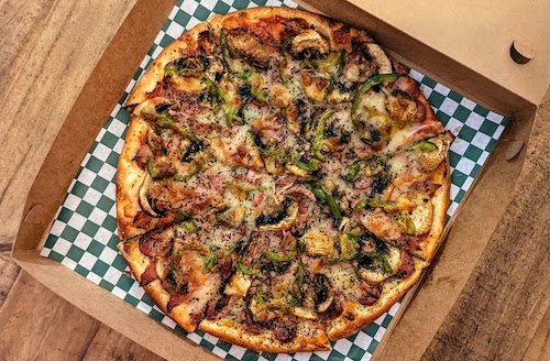 "Persepolis" pizza with sossis, mortadella, green peppers, and mushrooms