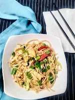 Serving chicken hakka noodles in a bowl, chopsticks in background