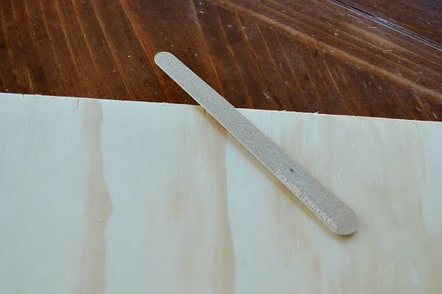 Using an emery board to file wood