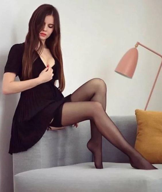 The lovely Ariadna is wearing a black dress with black stockings