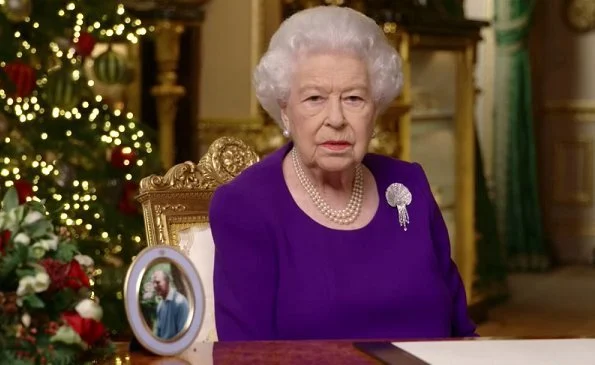 Queen Elizabeth wore an Angela Kelly rich purple dress with a Queen Mother diamond and mother of pearl shell brooch. The Duchess of Cambridge