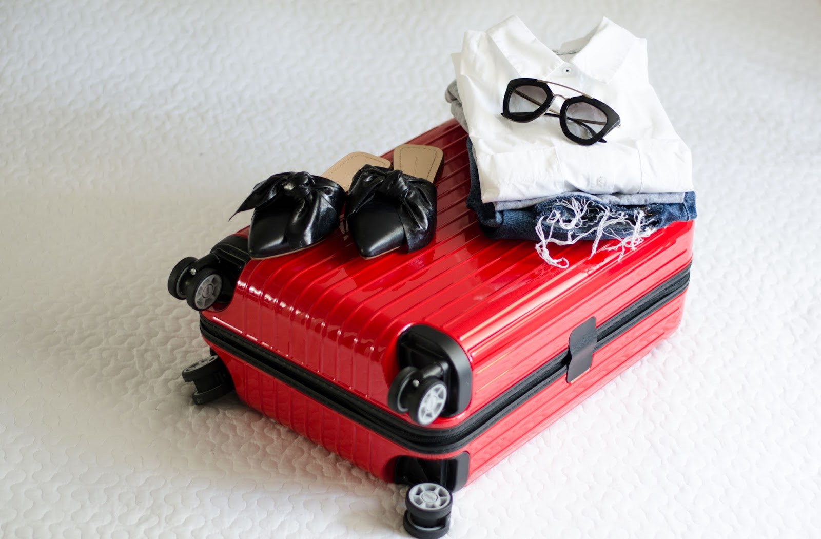 rimowa suitcase prada sunglasses zara flat mule loafers