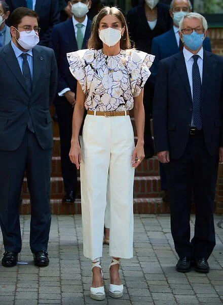 Queen Letizia wore a new double sleeve ruffle top from Psophia, and white suede espadrille wedges from Macarena, and Castaner wedges