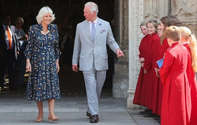 Charles wearing a crisp grey suit and Camilla wore her favourite dress by Fiona Clare