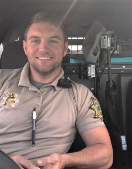 handsome-policeman-county-sherrif-car-smiling-officer