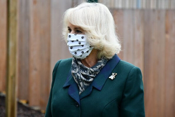 The Duchess of Cornwall is patron of the charity Battersea. Battersea introduced online puppy training classes. The Duchess wore a green wool coat