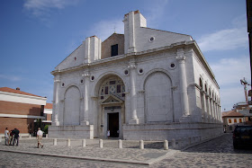 The 13th century Tempio Maletestiano in Rimini has frescoes by Piero della Francesca and works by Giotto
