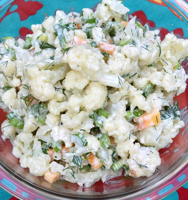 Cauliflower and dill salad in a glass bowl