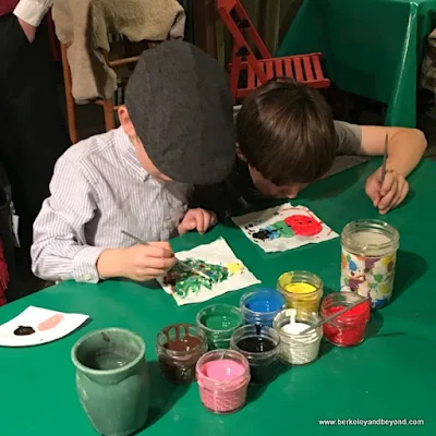 boys paint ornaments at The Great Dickens Christmas Fair in San Francisco