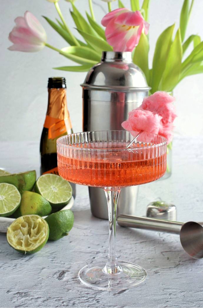 Sparkling-Cotton-Candy-Cosmopolitan-1 Recipe for a Cosmopolitan cocktail version with vodka, cranberry juice, triple sec, lime juice, prosecco and cotton candy.