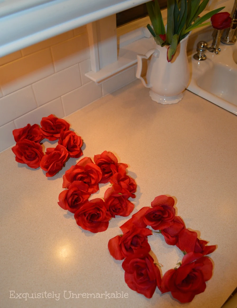 Three red rose mini rose wreaths on counter