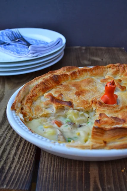 Cheesy Vegetable Puff Pie in a pie dish with a pastry bird to let out steam