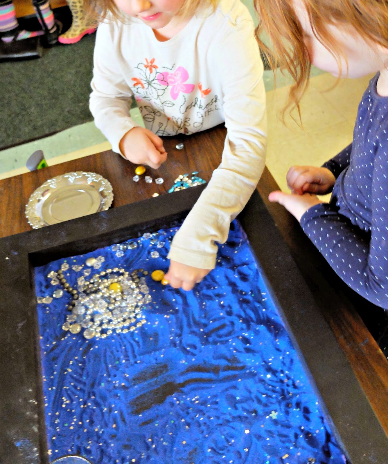 Starry Night sensory tray - rubber boots and elf shoes