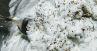 Mayonnaise mixed with ingredients for tartar sauce recipe for fish fingers