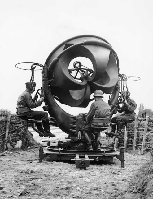 Sound location equipment in Germany, 1939. It consists of four acoustic horns, a horizontal pair and a vertical pair, connected by rubber tubes to stethoscope type earphones worn by the two technicians left and right. The stereo earphones enabled one technician to determine the direction and the other the elevation of the aircraft.