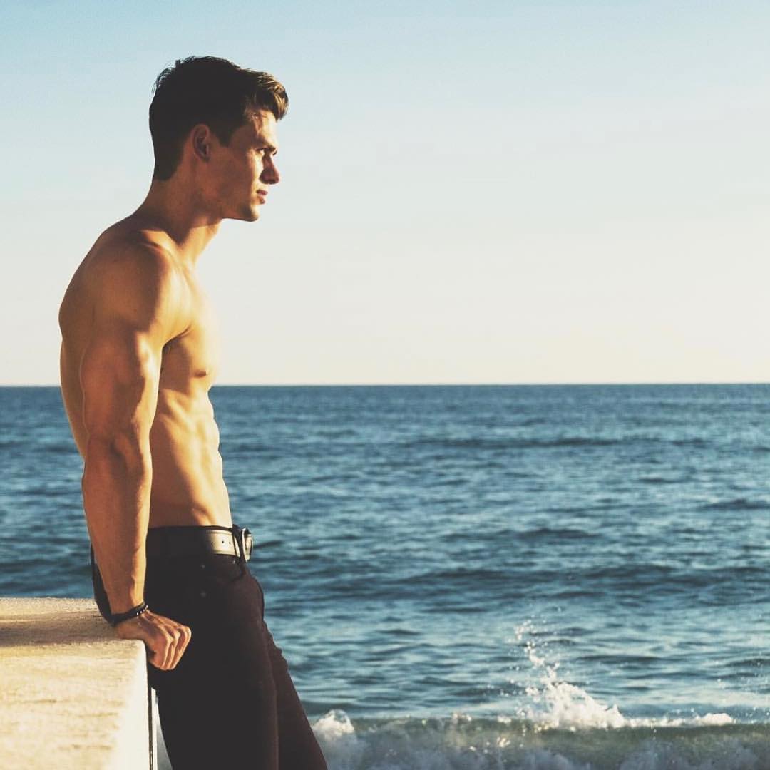 hot-fit-shirtless-male-model-enjoying-ocean-view