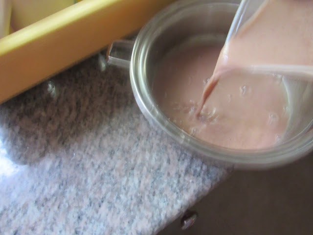 Pouring mixed guinea corn flour into a cooking pot