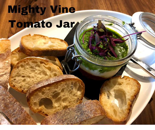 Mighty Vine Tomato Jar at Hey Nonny in Arlington Heights, Illinois featuring Mighty Vine tomatoes, stracciatella cheese and fresh herb pesto.