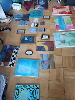 some paintings layed out on the floor