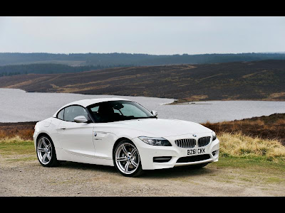  BMW Z4  The BMW Z4 is a rear-wheel drive sports car by the German car maker BMW. It follows a line of past BMW roadsters such as the BMW Z1, BMW 507, BMW Z8, and the BMW Z3. The Z4 replaces the Z3. Starting with the 2009 model year, the second-generation Z4 is built at BMW's Regensburg, Germany plant as a retractable hardtop roadster. In 2009, the BMW Z4 won the Red Dot Design Award