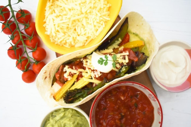 STEP 5 - Fajitas loaded high with guacamole, vegetables, salsa, grated cheddar and sour cream