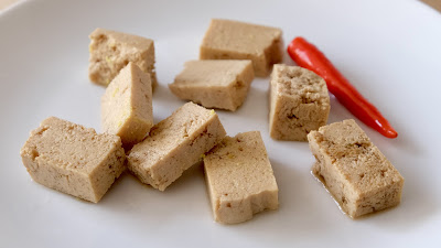 Marinaded tofu square peices with a red chilli
