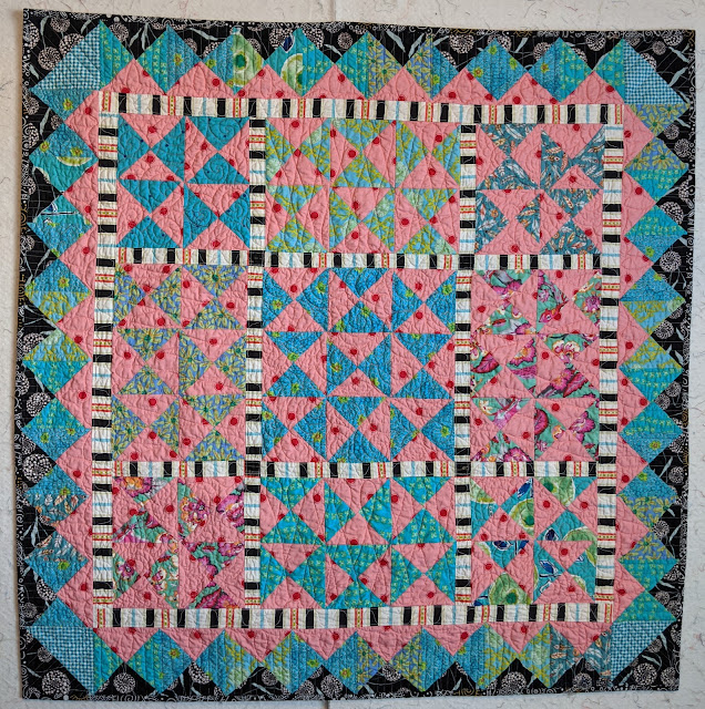 Improv Hourglass quilt 1 in blue, pink, and black
