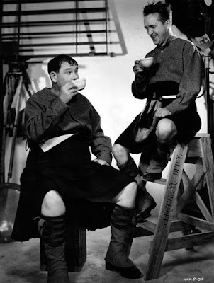 Laurel & Hardy relax during filming of "Bonney Scotland"