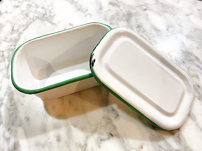 green enamelware container with a lid