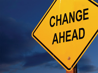 A picture of a road sign that says change ahead